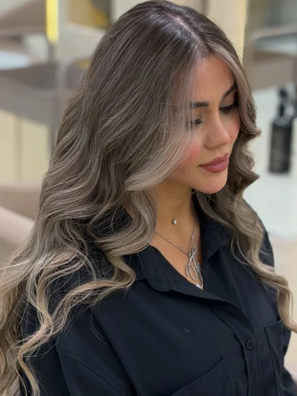 Silver blonde hair styled with cool undertones for a striking, icy finish.