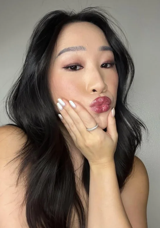 Soft plum lipstick adding cool-toned depth to a fair complexion.