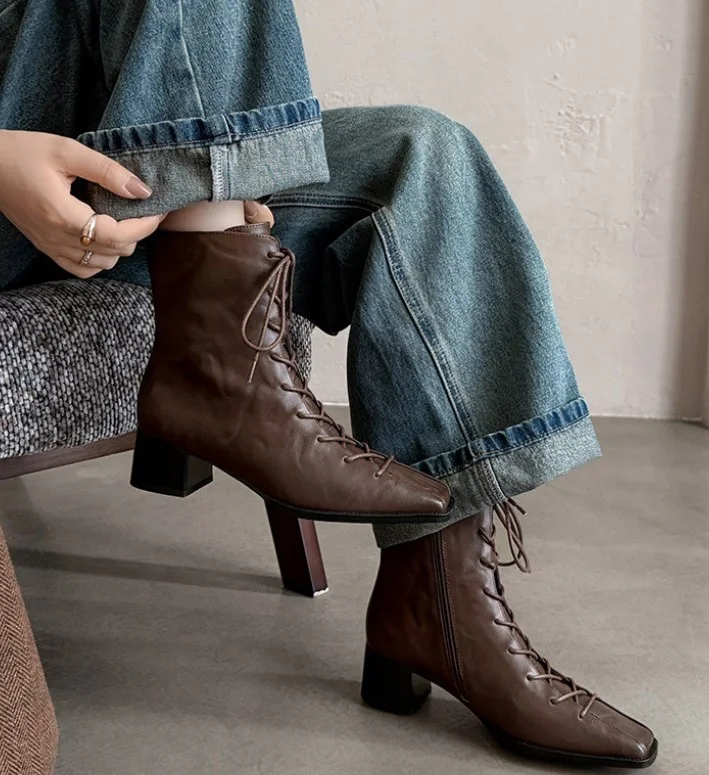 Wide leg jeans worn with square-toe boots for winter.