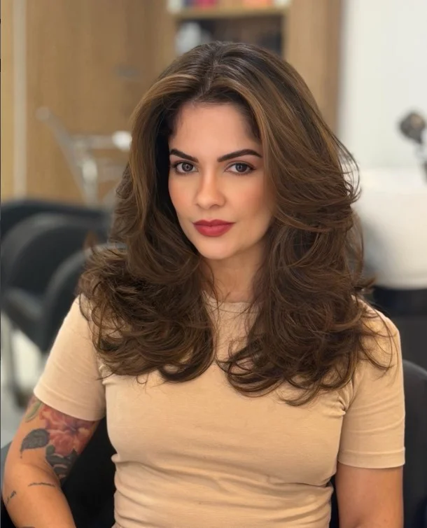 Warm chocolate brown hair styled with a glossy finish for a balanced complexion.