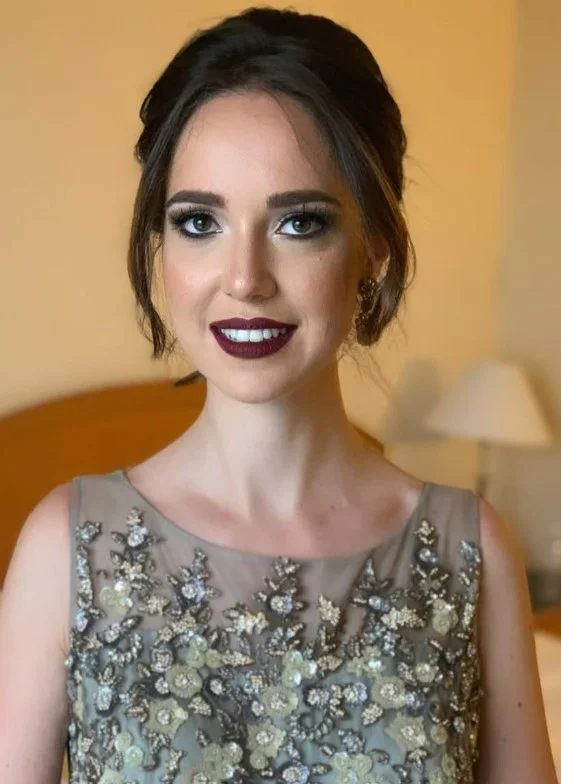Wine red lipstick creating an elegant evening makeup look for fair skin.