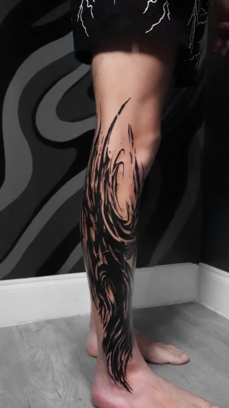 Abstract flowing half leg tattoo for women with organic shapes and negative space