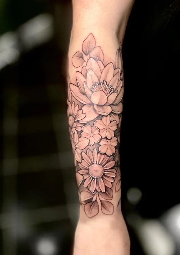 Birth flower forearm tattoo featuring a meaningful floral design