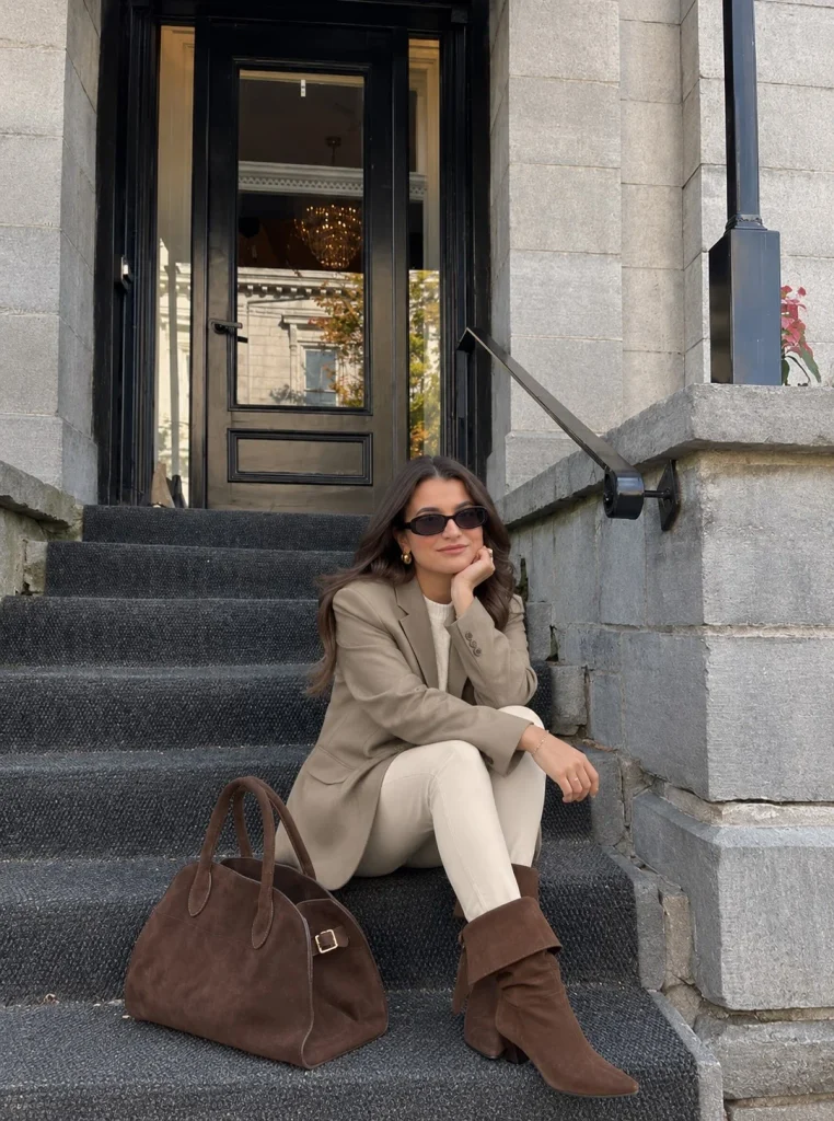 Woman wearing a blazer, slim trousers, and brown fold over boots