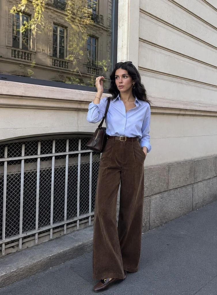 Woman wearing corduroy wide-leg pants with a button-down shirt and loafers