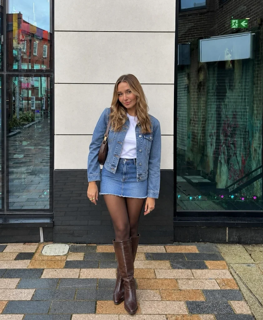 Denim mini skirt with denim jacket, white tee, and brown boots for fall