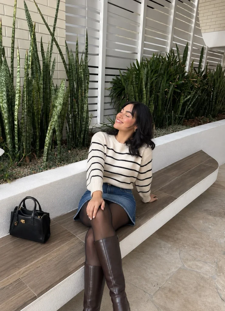 Denim mini skirt with striped sweater, tights, and knee-high boots for fall