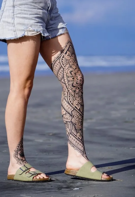Geometric blackwork half leg tattoo for women with bold shapes and negative space