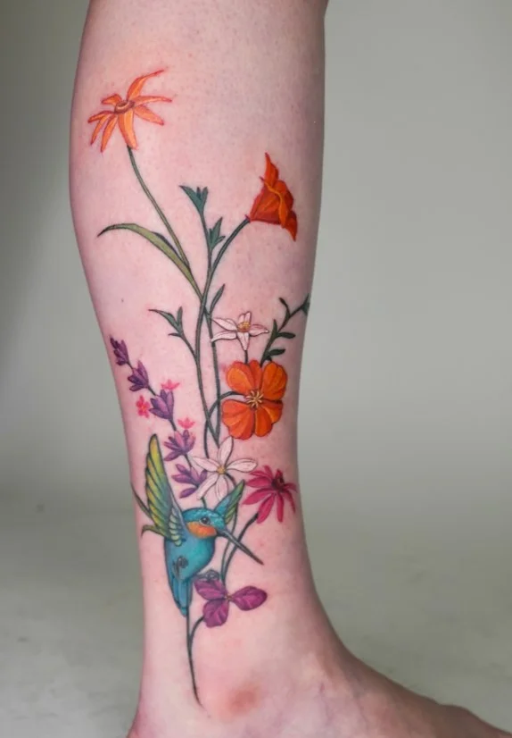 Hummingbird and tropical flowers half leg tattoo for women