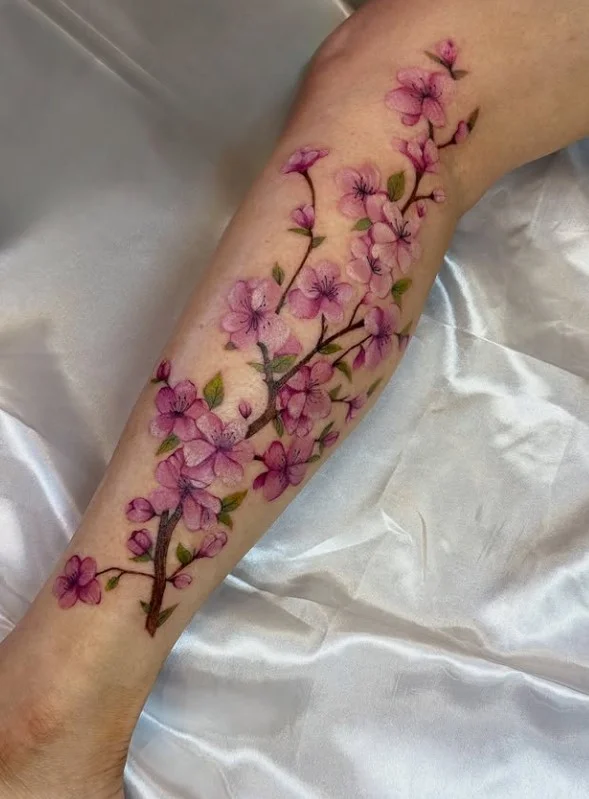 Japanese cherry blossom half leg tattoo for women with flowing branches