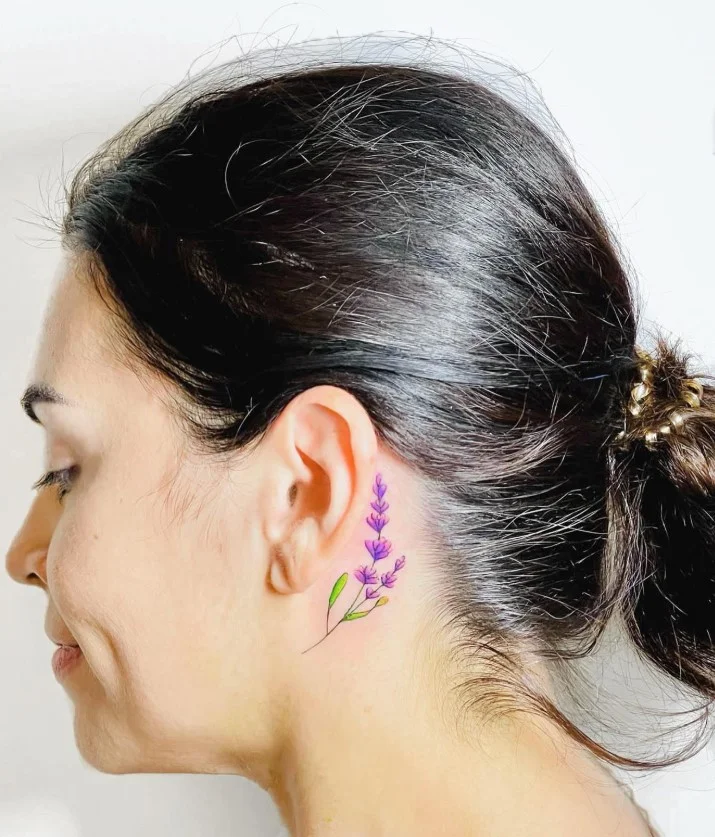 Lavender sprig behind the ear tattoo with a delicate botanical design