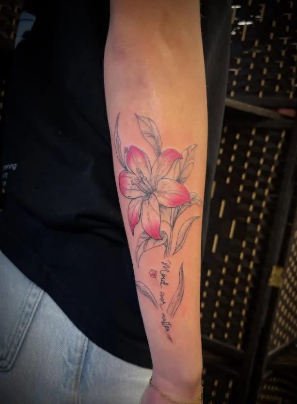 Lily forearm tattoo with an elegant elongated floral design