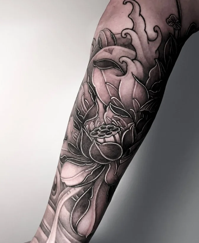Lotus flower forearm tattoo with a symmetrical layered bloom