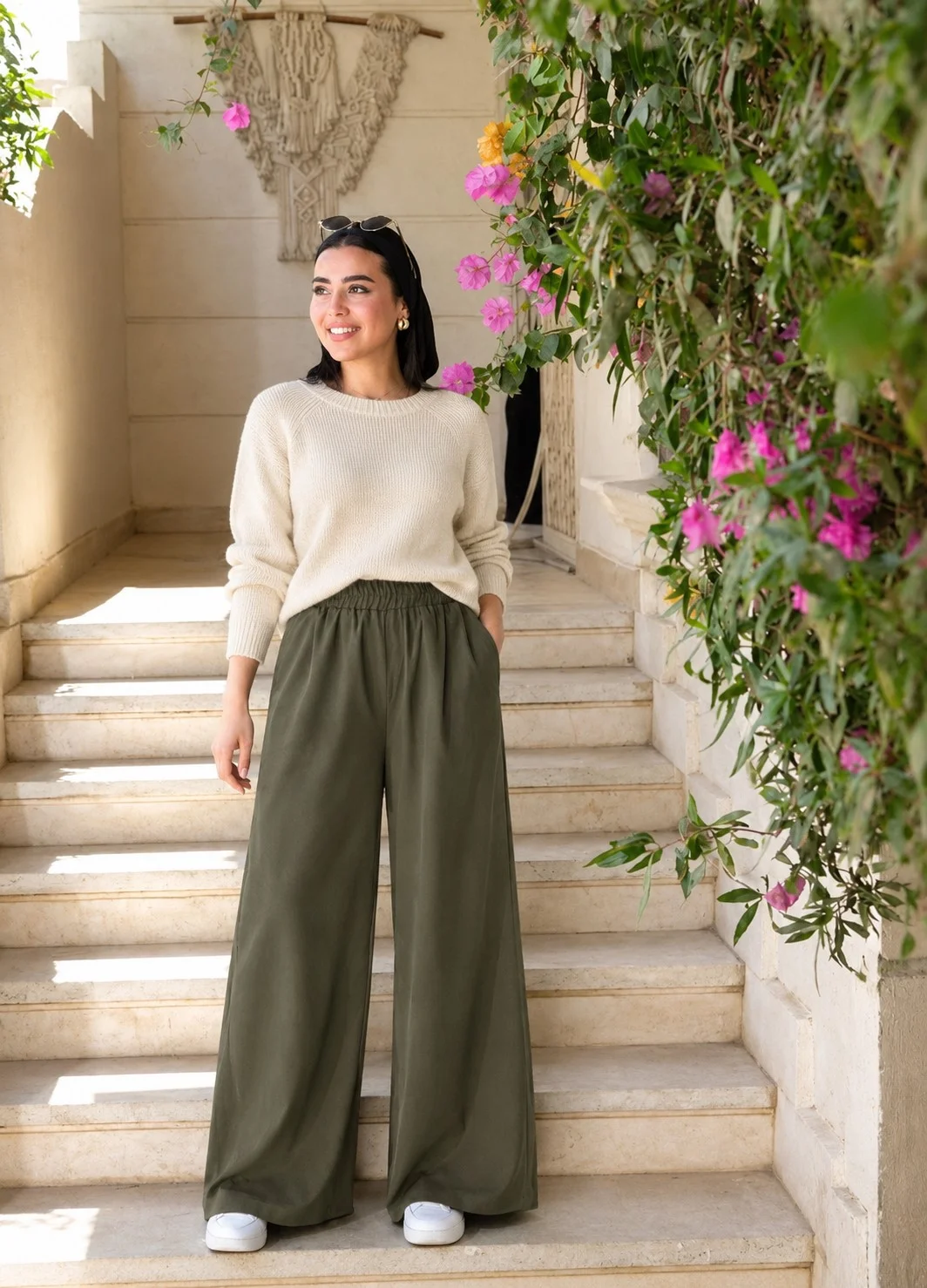 Woman wearing olive wide-leg pants with a cream sweater and sneakers