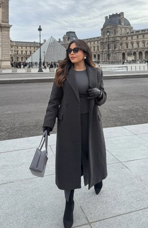 Woman wearing pointed-toe boots with a monochrome winter outfit