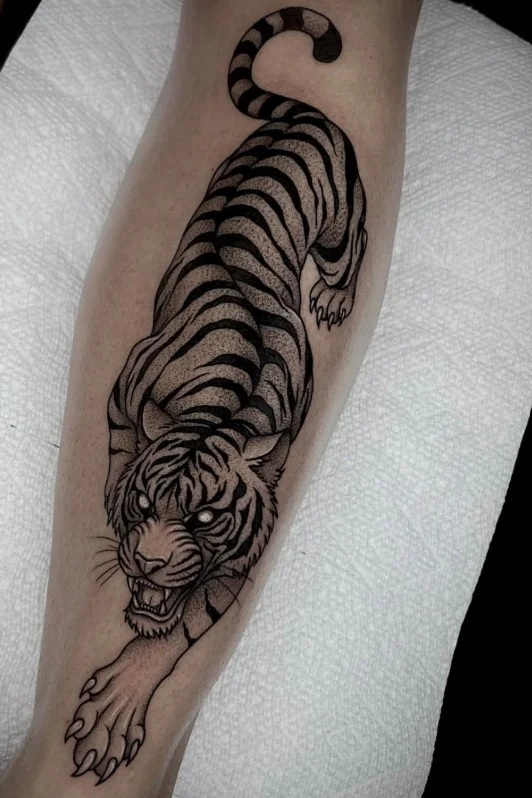 Realistic tiger half leg tattoo for women with detailed black and grey shading