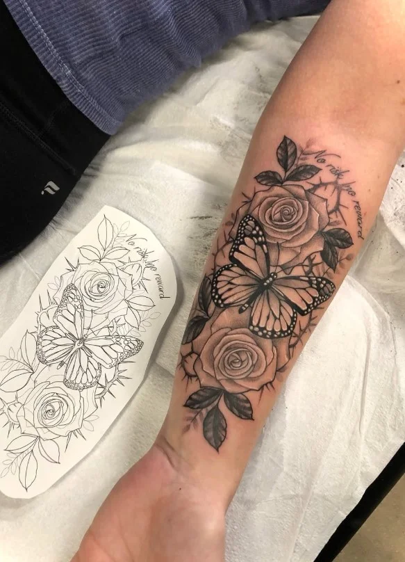 Rose and butterfly forearm tattoo combining a flower with a delicate butterfly