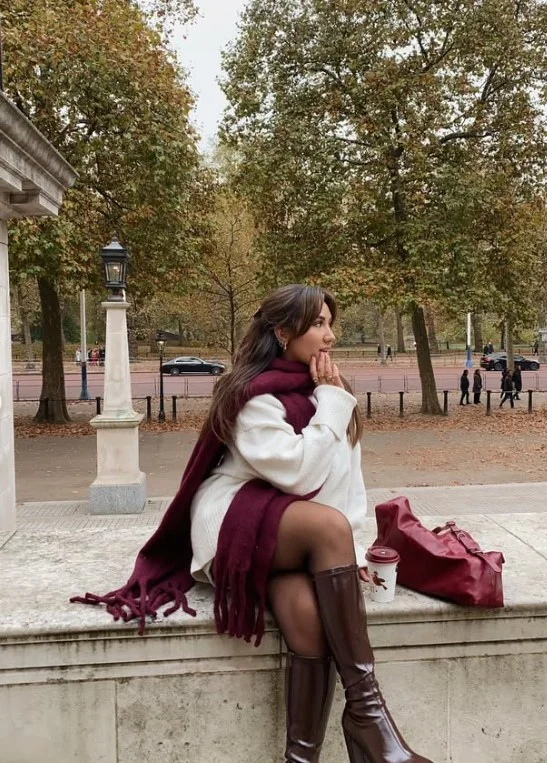 Tailored shorts and tights styled with dark brown knee high boots