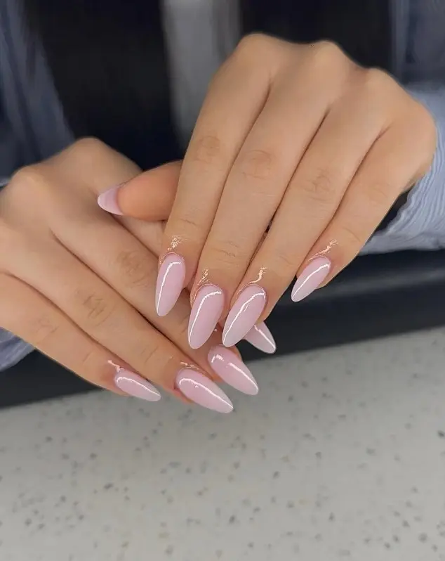 Glossy baby pink acrylic nails in an almond shape with a smooth, feminine finish.