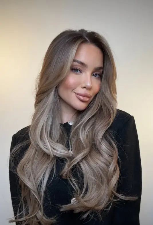 Beige blonde balayage with softly blended neutral blonde highlights and darker natural roots
