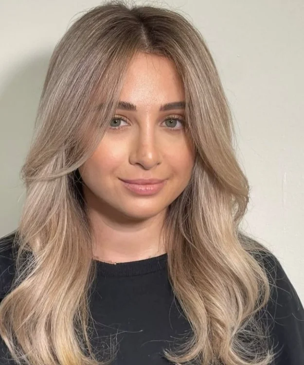 Soft beige blonde hair with neutral tones on olive skin