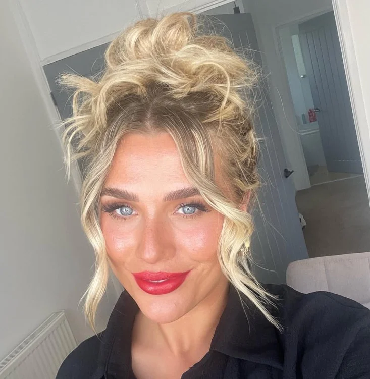 Woman wearing rich brick red lipstick with warm brown undertones on brown skin