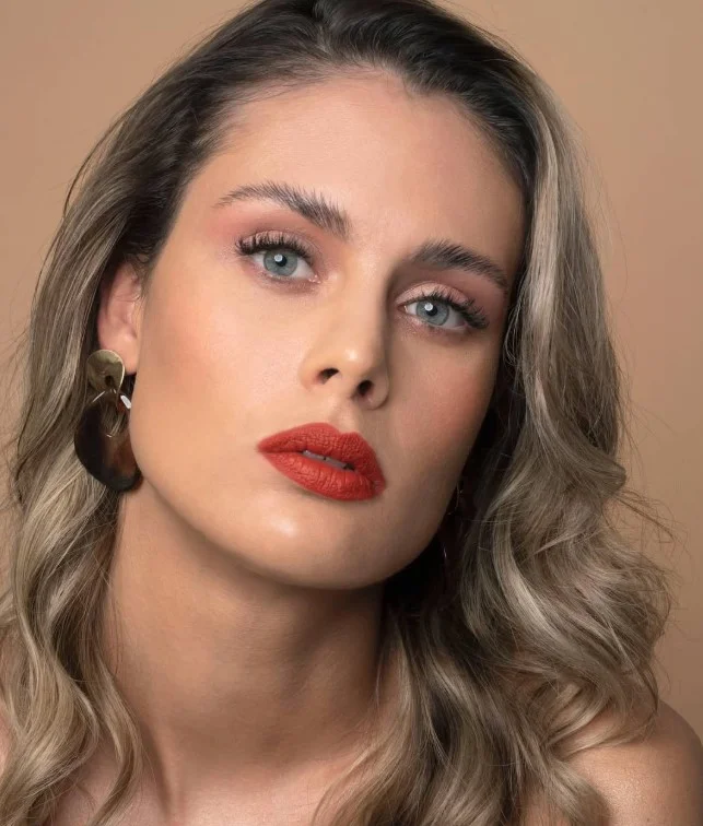 Burnt orange lipstick in a deep, earthy orange shade for bold makeup.