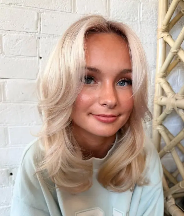 Butter blonde hair with creamy golden tones for a warm, soft blonde look on pale skin