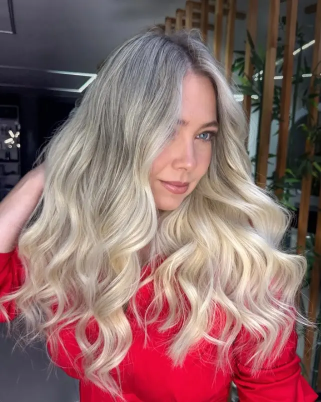 Cool ash blonde hair with smoky muted tones that complement pale skin with pink undertones