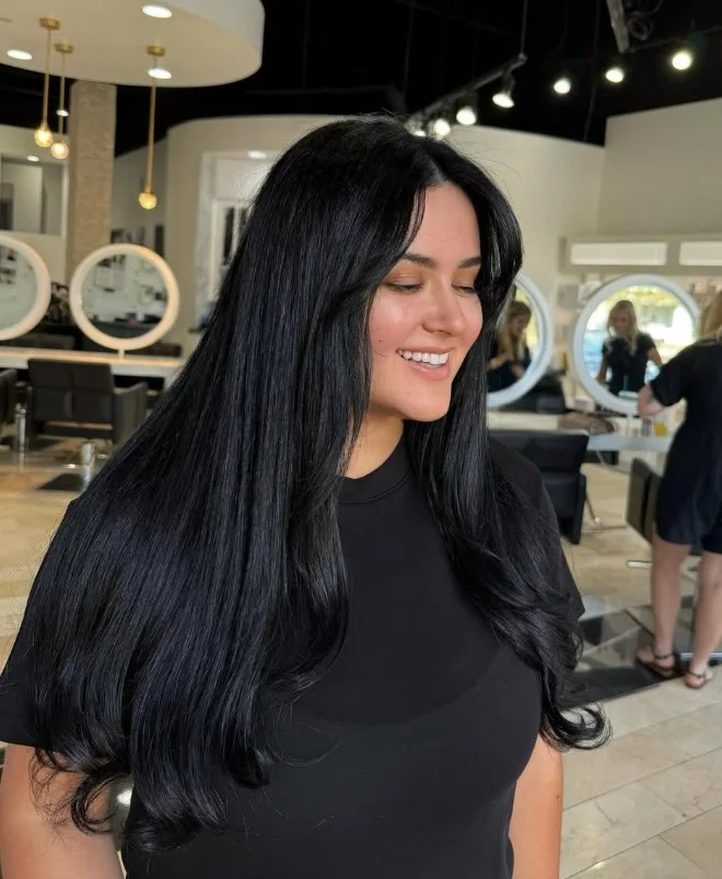 Dark blue-black hair with cool blue undertones and a glossy finish
