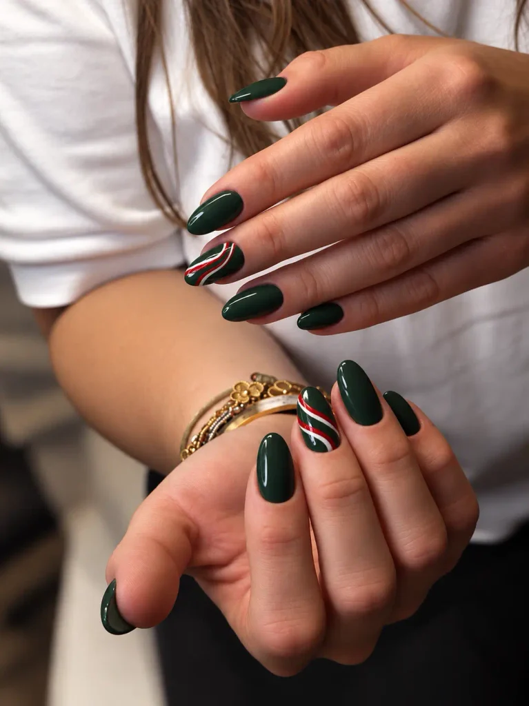 Dark green Christmas nails with curved red and white candy cane stripes on accent nails