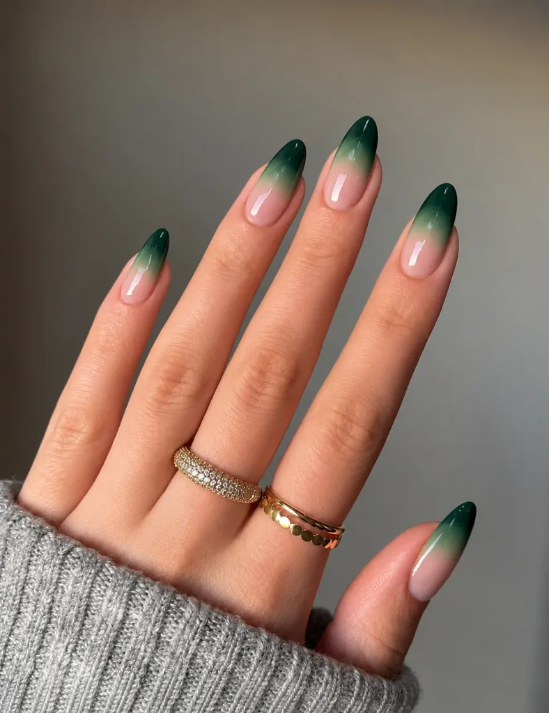 Dark green ombre Christmas nails blending emerald green into deep forest green with a smooth gradient