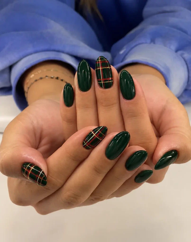 Dark green Christmas tartan nails with intersecting red, cream, and gold plaid lines