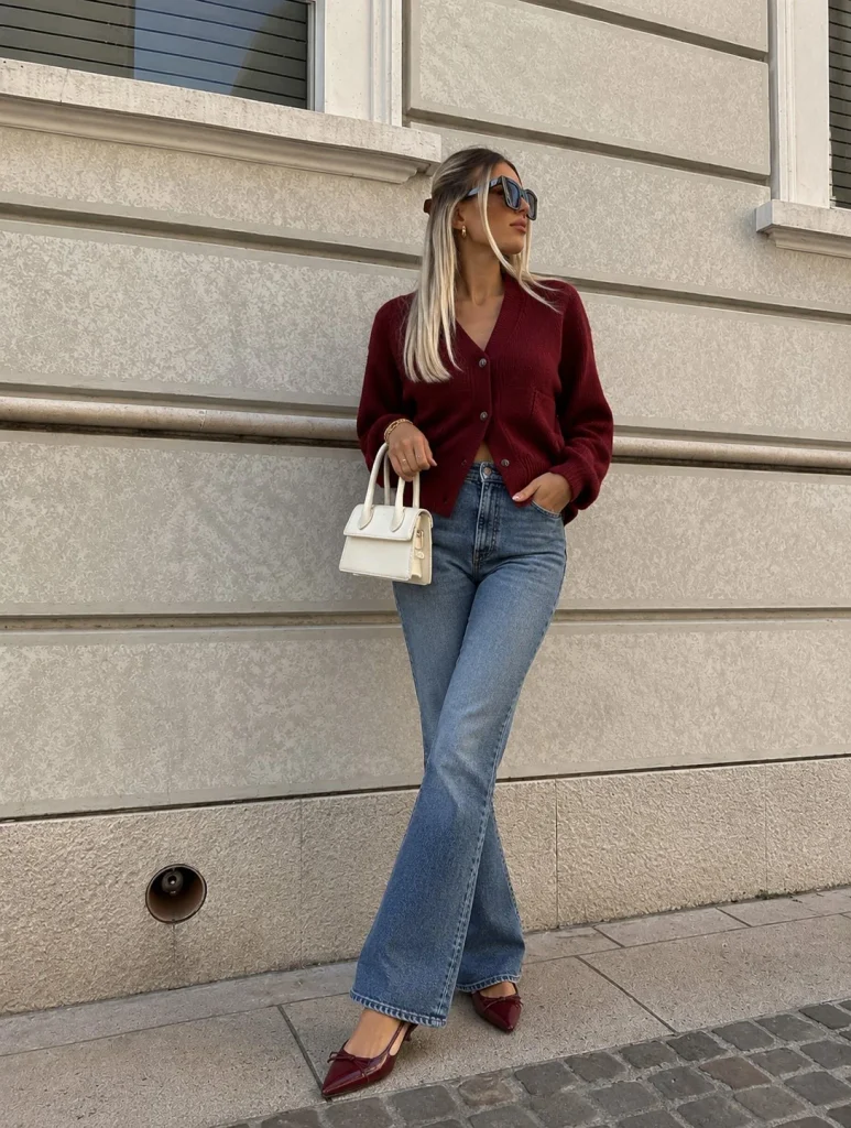 Dark red cardigan with medium-wash bootcut jeans and dark red slingback flats