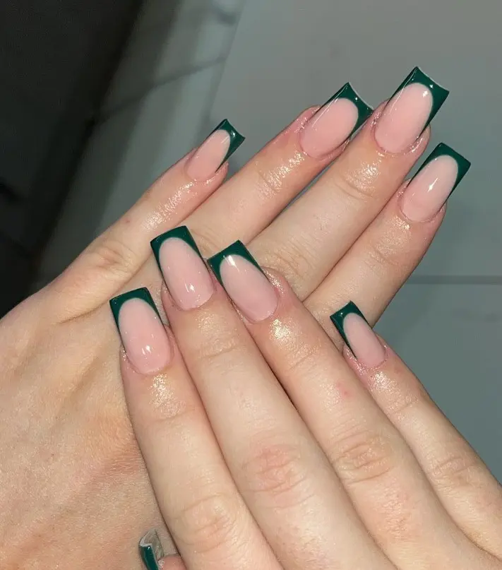 Emerald green Christmas French tip nails with clean green tips over a sheer pink base