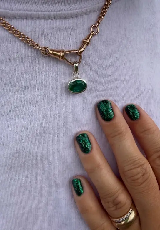 Emerald green glitter Christmas nails with rich jewel-toned polish and sparkling full-coverage shine