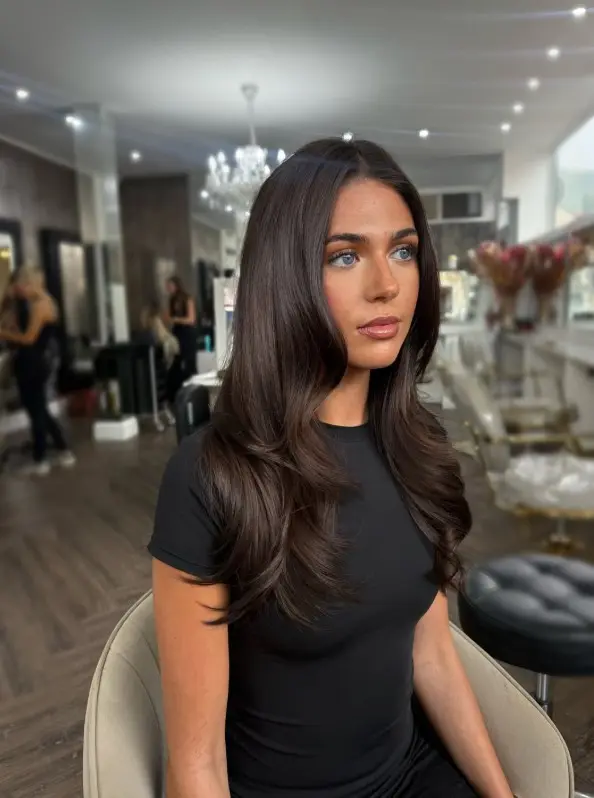 Glossy chocolate brown hair with rich warm brunette tones that contrast with pale skin and blue eyes