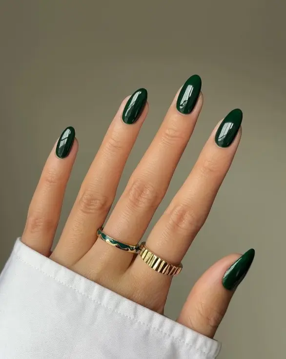 Glossy dark forest green Christmas nails with a smooth high-shine finish on short square or rounded nails