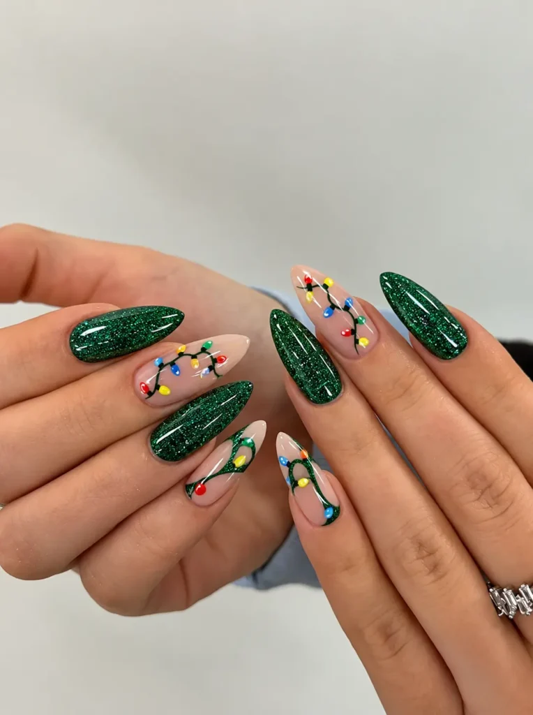 Green glitter Christmas nails with colorful red, yellow, blue, and white Christmas lights on an accent nail