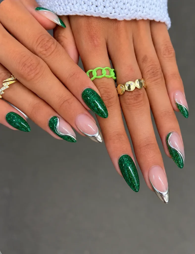 Green glitter Christmas nails with reflective silver chrome accents and metallic details