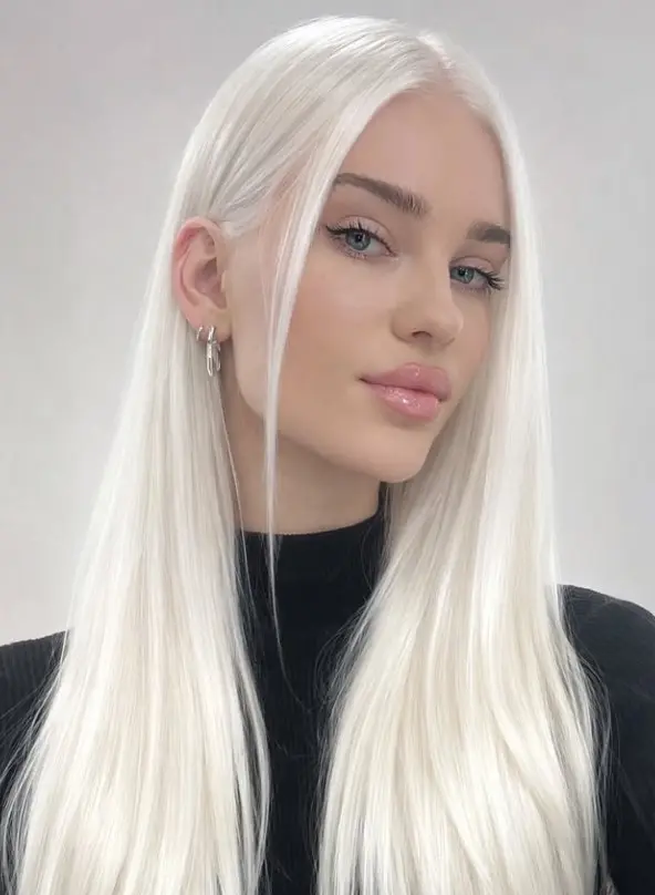 Icy platinum blonde hair in an almost-white cool shade that creates high contrast with pale skin and blue eyes