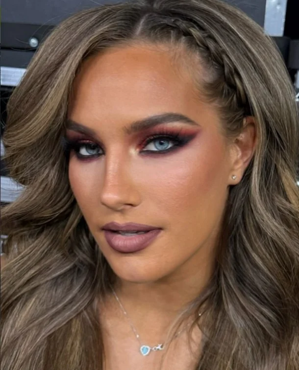 Woman wearing cool mauve lipstick with soft pink-purple tones on brown skin