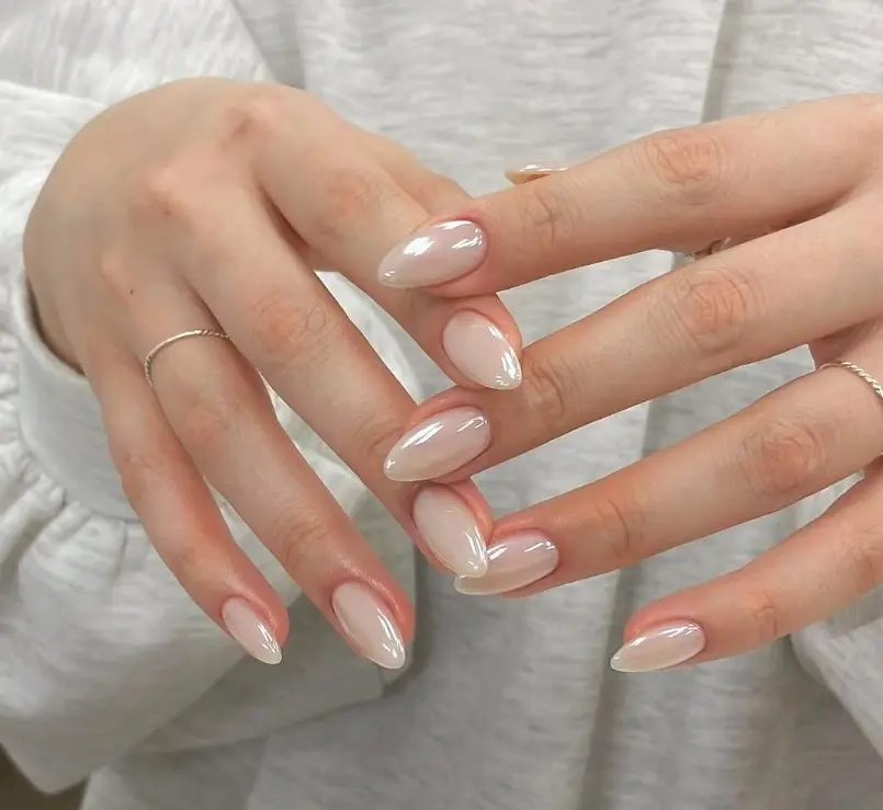 Milky white chrome acrylic nails with a pearly, reflective finish and a glossy surface.