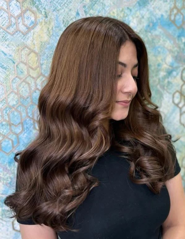 Rich mocha brown hair with subtle dimension on olive skin