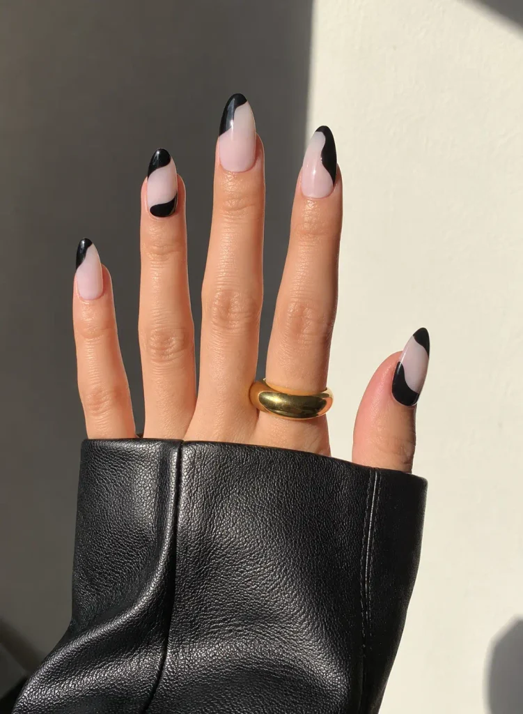 Nude negative-space acrylic nails featuring minimalist black curved lines and uncovered sections.
