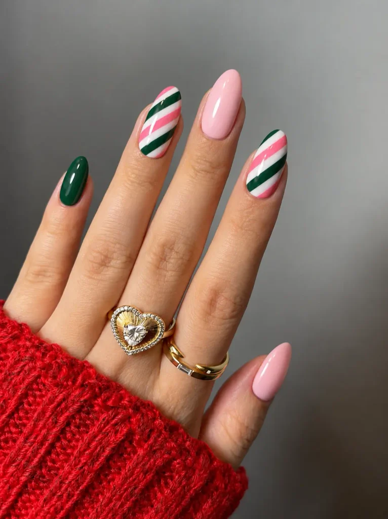 Pink, green, and white candy cane Christmas nails with curved diagonal stripes