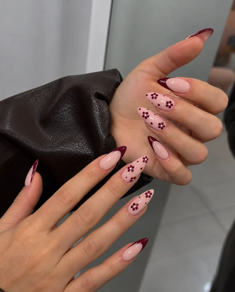 Pink nails decorated with small flowers made from burgundy dots