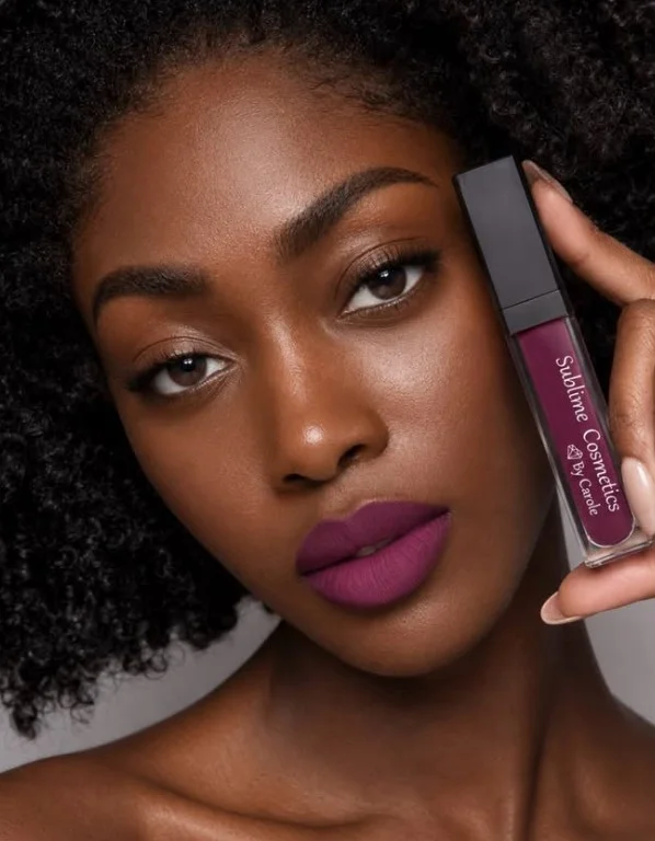 Woman wearing sophisticated plum lipstick with deep purple tones on brown skin