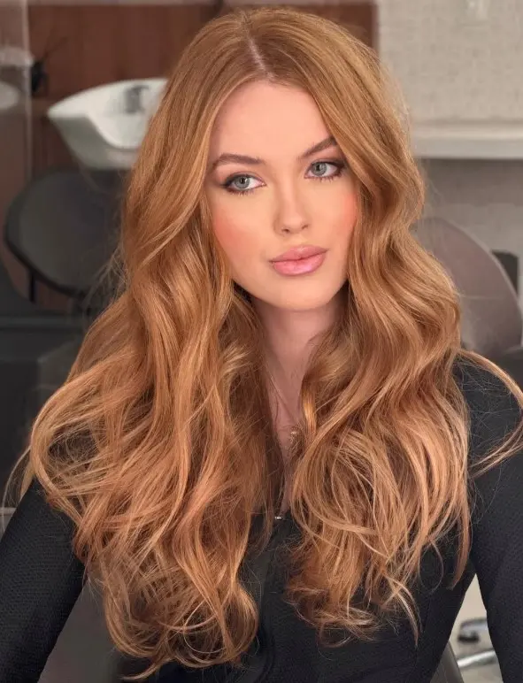 Strawberry blonde hair blending golden blonde with a delicate rosy red tint for pale skin and blue eyes